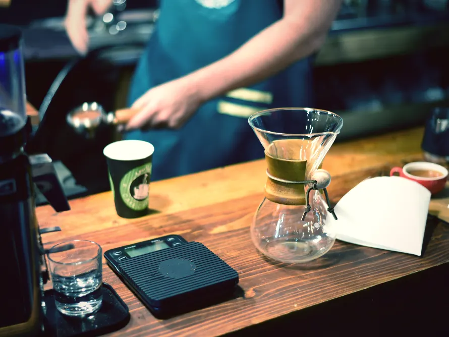 A barista pouring at a coffee bar, shot for a second site opening