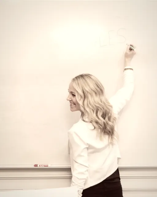 A woman walking through a plan on a whiteboard