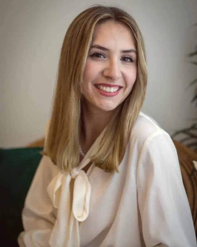 A smiling founder photographed in her workspace